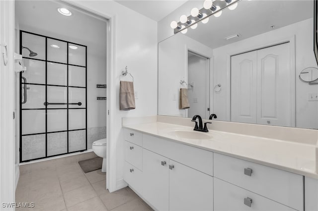 bathroom with walk in shower, vanity, tile patterned flooring, and toilet