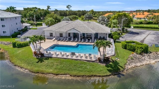 exterior space featuring a patio, a yard, and a water view