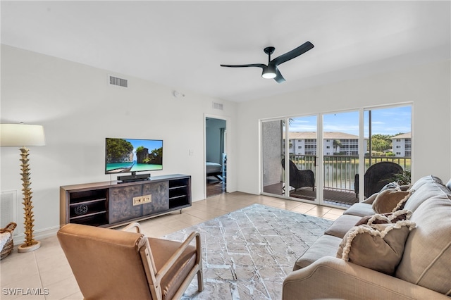 tiled living room with ceiling fan