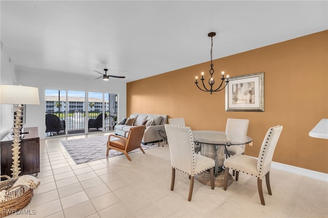 dining area with ceiling fan with notable chandelier and light tile patterned floors