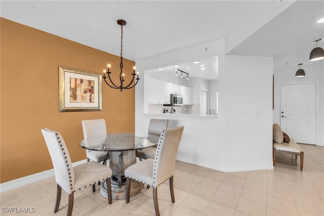 tiled dining room featuring a notable chandelier