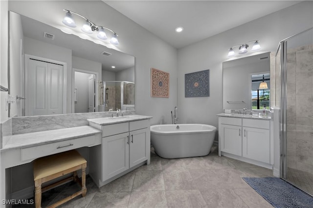 bathroom with vanity and separate shower and tub