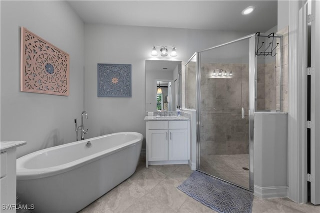 bathroom with vanity and independent shower and bath