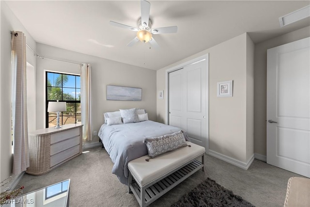 bedroom with ceiling fan, a closet, and light carpet