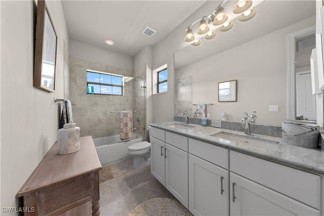 full bathroom with vanity, tiled shower / bath combo, and toilet