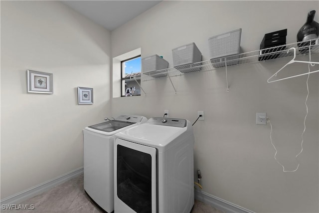 washroom with washing machine and clothes dryer