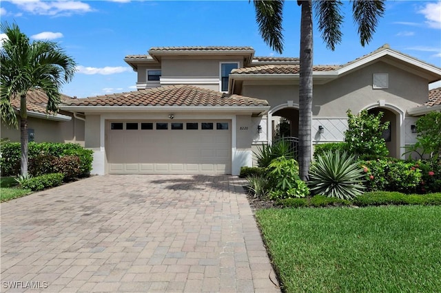 mediterranean / spanish house with a garage