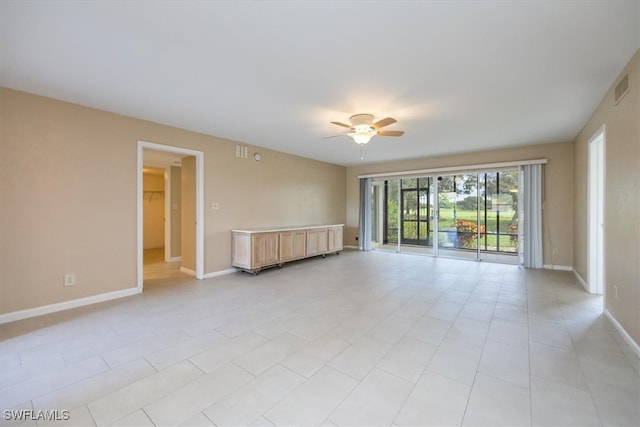 empty room with light tile patterned floors and ceiling fan