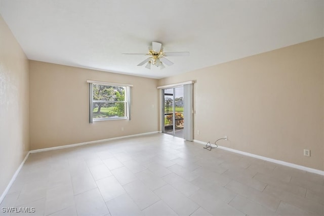 tiled empty room with ceiling fan