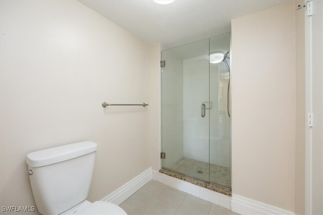 bathroom with walk in shower, toilet, and tile patterned floors