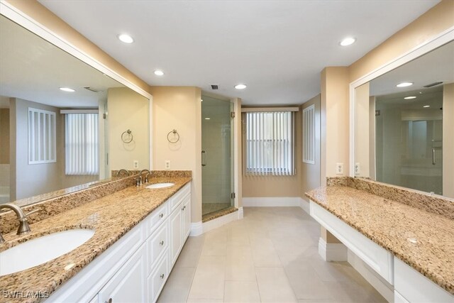 bathroom featuring vanity, tile patterned floors, and an enclosed shower