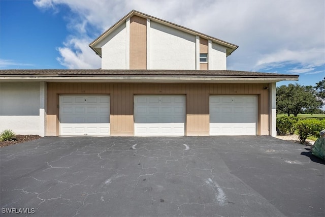 garage featuring wooden walls