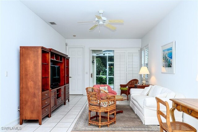 tiled living room with ceiling fan