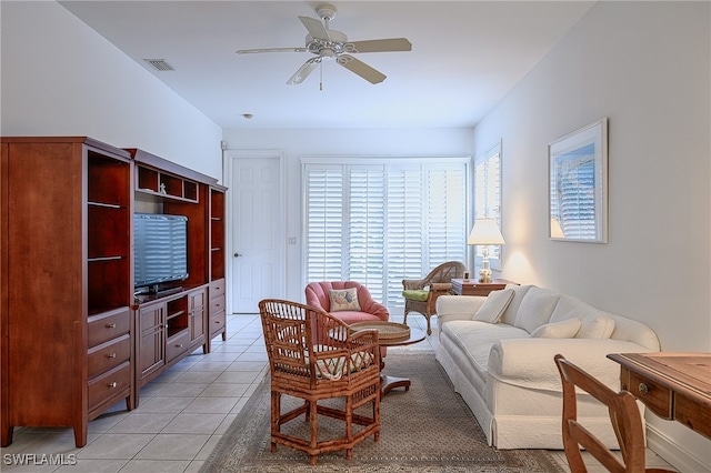 tiled living room featuring ceiling fan and plenty of natural light