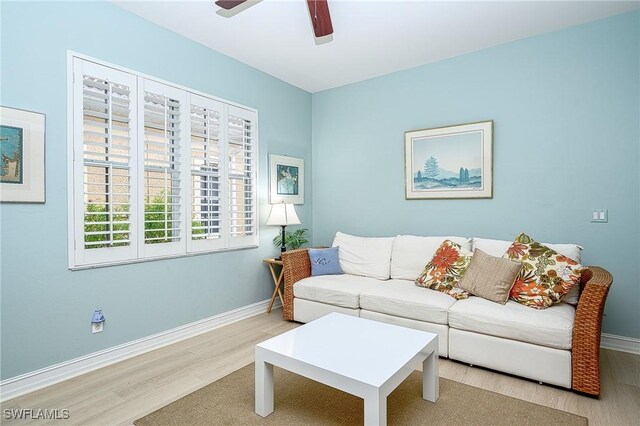 living room featuring light wood-type flooring and ceiling fan