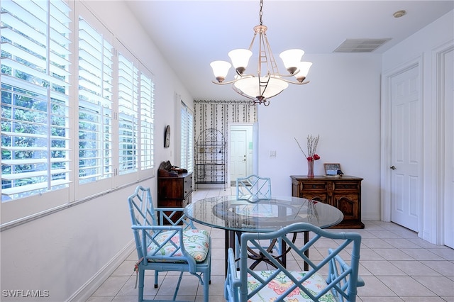 tiled dining area with a chandelier