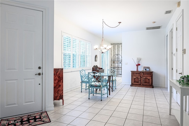 tiled dining room featuring a chandelier