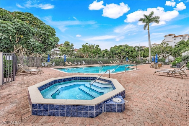 view of pool featuring a community hot tub and a patio