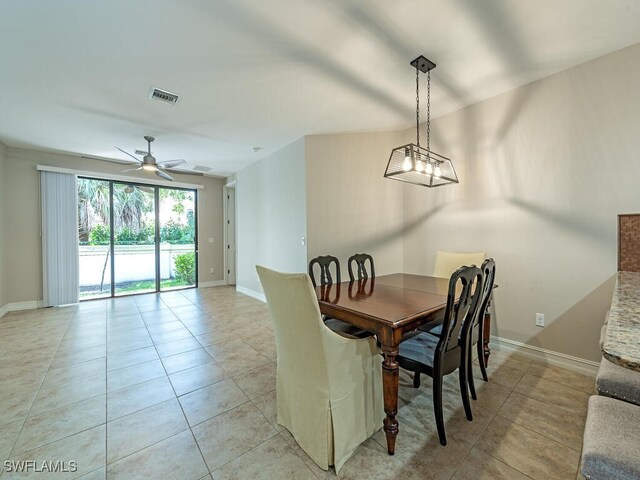 tiled dining space with ceiling fan