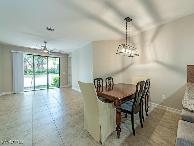 dining space featuring visible vents, a ceiling fan, baseboards, and light tile patterned floors