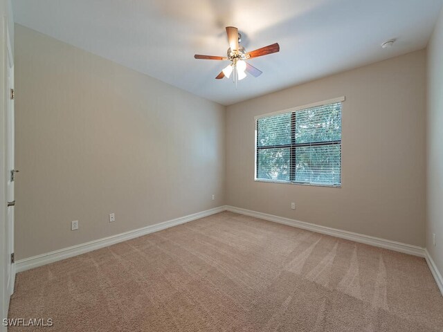 empty room featuring light carpet and ceiling fan