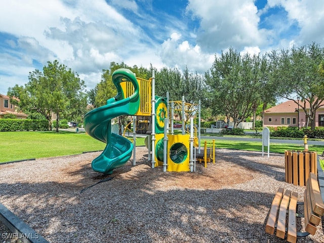 community jungle gym featuring a yard