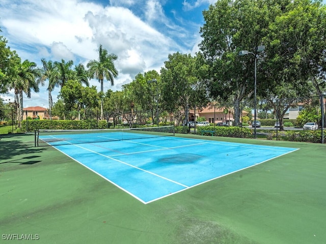view of tennis court with fence