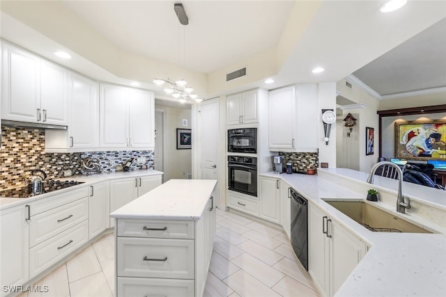 kitchen featuring sink, hanging light fixtures, black appliances, white cabinets, and kitchen peninsula