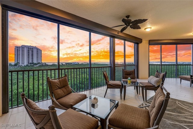 sunroom featuring ceiling fan