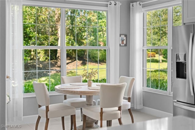 tiled dining area with a healthy amount of sunlight