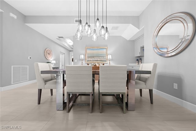 dining area featuring an inviting chandelier and light tile patterned flooring