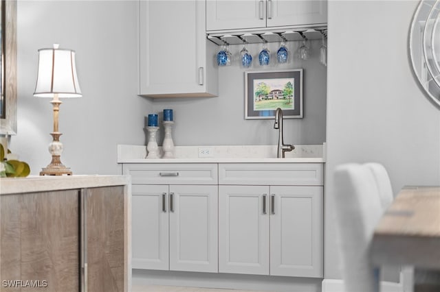 kitchen with white cabinetry and sink