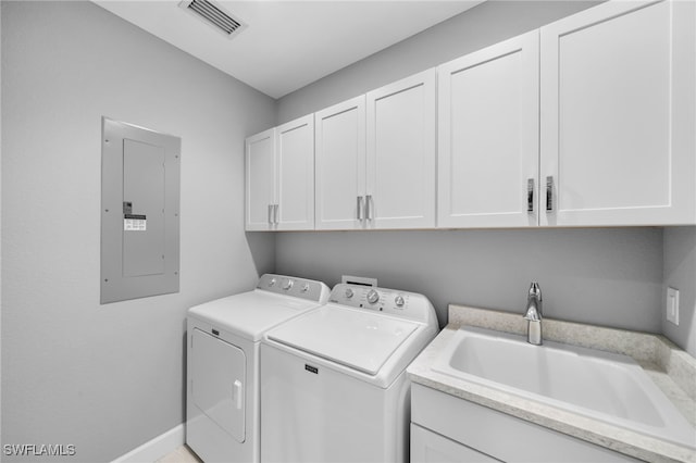 laundry room featuring cabinets, independent washer and dryer, electric panel, and sink