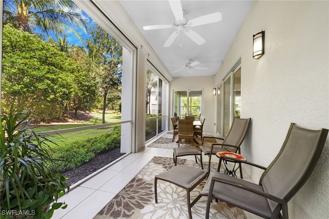 sunroom / solarium with lofted ceiling and ceiling fan