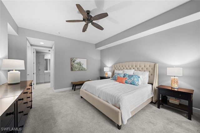 carpeted bedroom featuring ensuite bath and ceiling fan