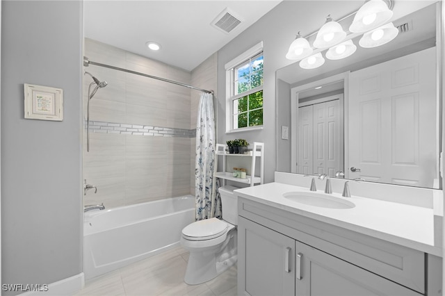 full bathroom featuring vanity, tile patterned floors, toilet, and shower / bath combo