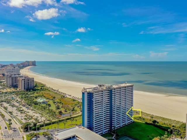 birds eye view of property with a water view and a view of the beach