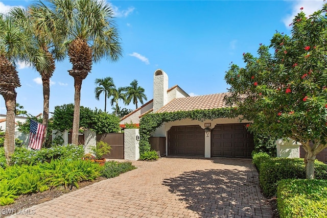 mediterranean / spanish-style home with a garage