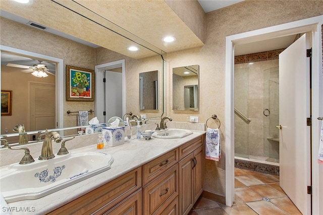 bathroom featuring tile patterned flooring, ceiling fan, walk in shower, and vanity