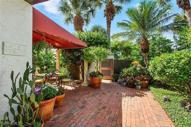 view of patio / terrace featuring outdoor dining area and fence