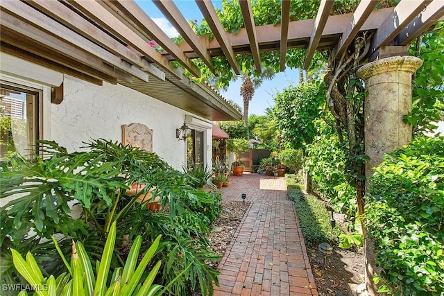 view of yard with a pergola, fence, and a patio