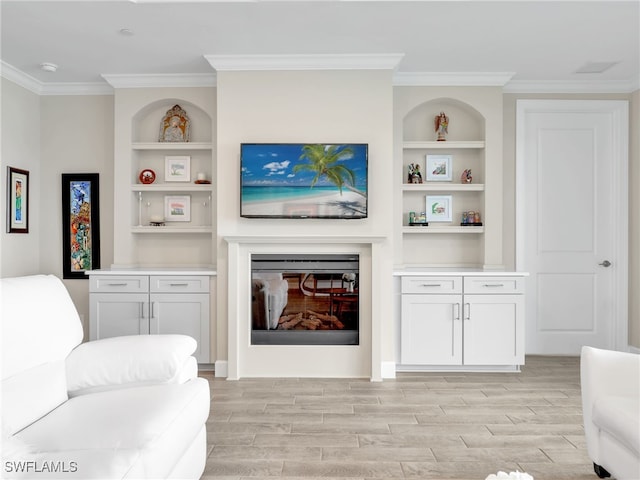 living room featuring built in features, light hardwood / wood-style floors, and ornamental molding