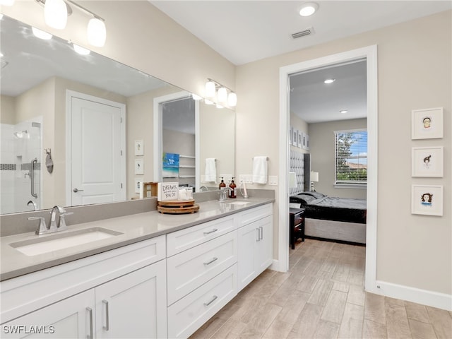 bathroom with vanity, wood-type flooring, and a shower with shower door