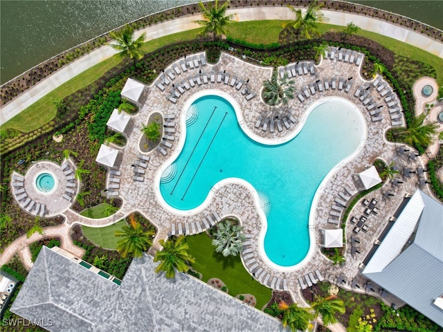 view of pool with a water view and a patio