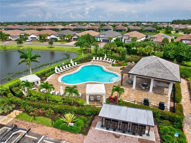 view of swimming pool featuring a water view, a patio area, and a gazebo