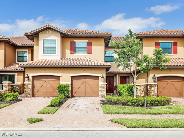 mediterranean / spanish-style house with a garage