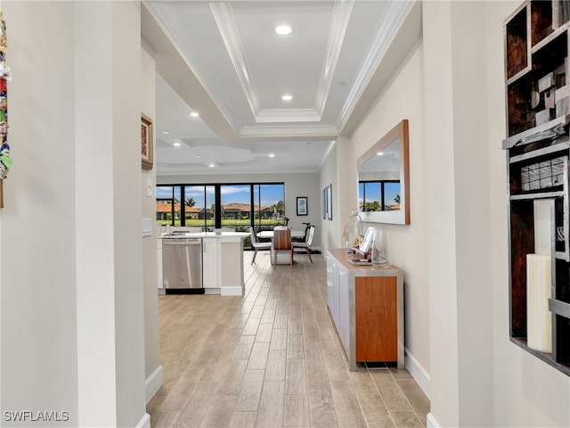 hall featuring a raised ceiling, crown molding, and light hardwood / wood-style flooring