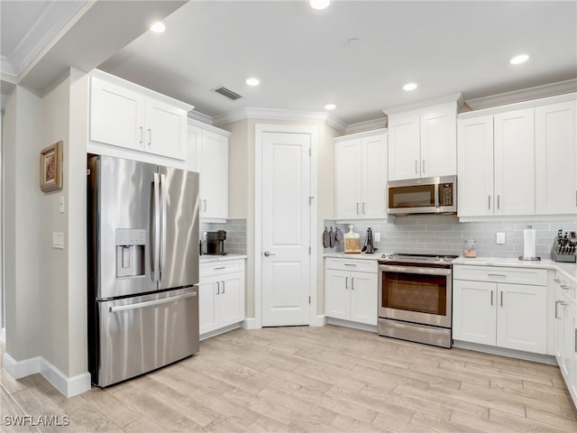 kitchen featuring appliances with stainless steel finishes and light hardwood / wood-style flooring