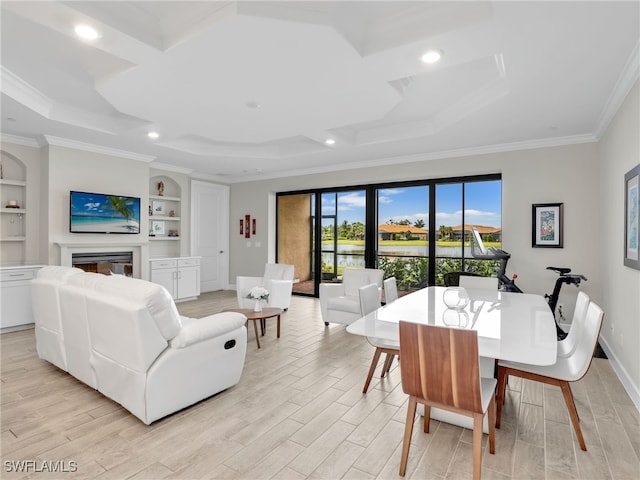 dining area with built in shelves, crown molding, and light wood-type flooring