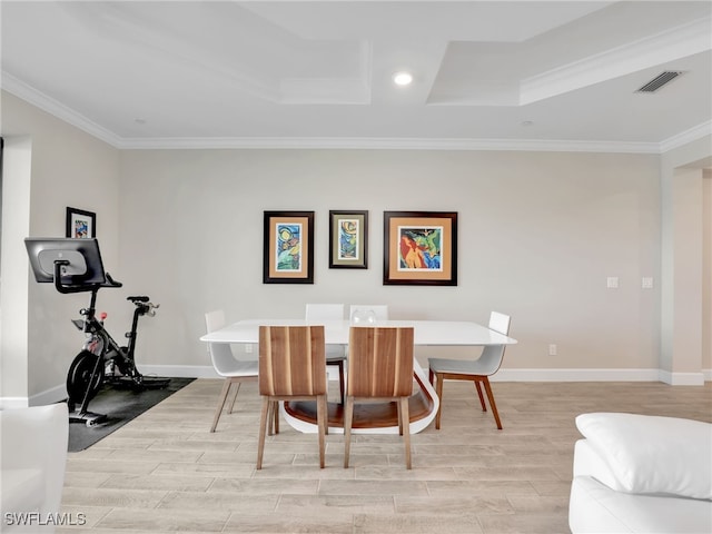 dining space featuring crown molding and light hardwood / wood-style flooring